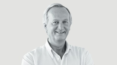 Black-and-white portrait of a white man with white hair