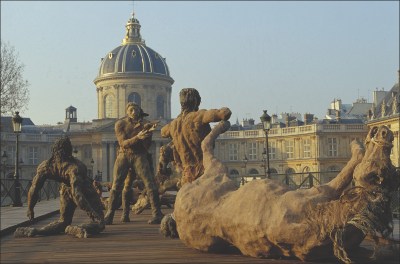 A monument showing a battle scene with a fallen horse