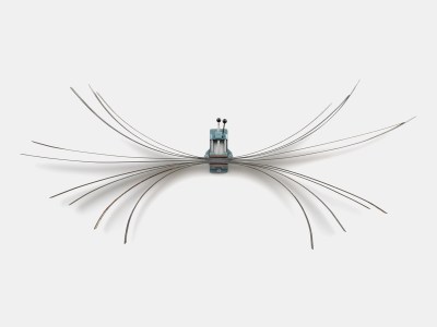 A wall-hung sculpture of various shards of steel fanned out and held together by a blue clamp. 